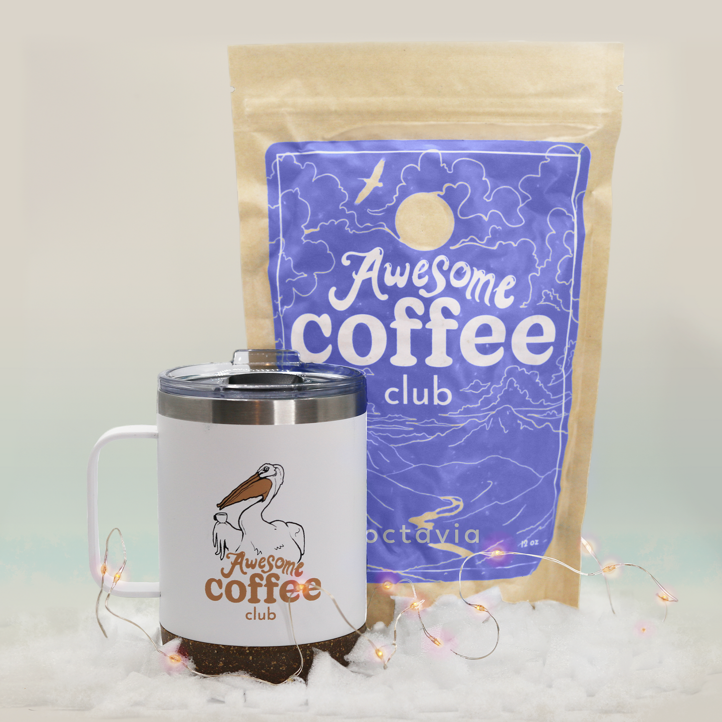 A bag of Octavia coffee from the Awesome Coffee Club with a dark purple label sits behind a white travel mug with a pelican and the Awesome Coffee Club logo. A Good Store product.