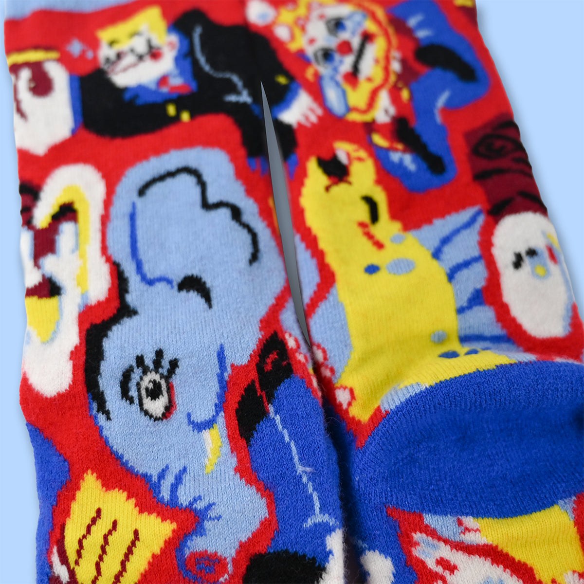 Colorful wool socks with cartoon characters on a light blue background