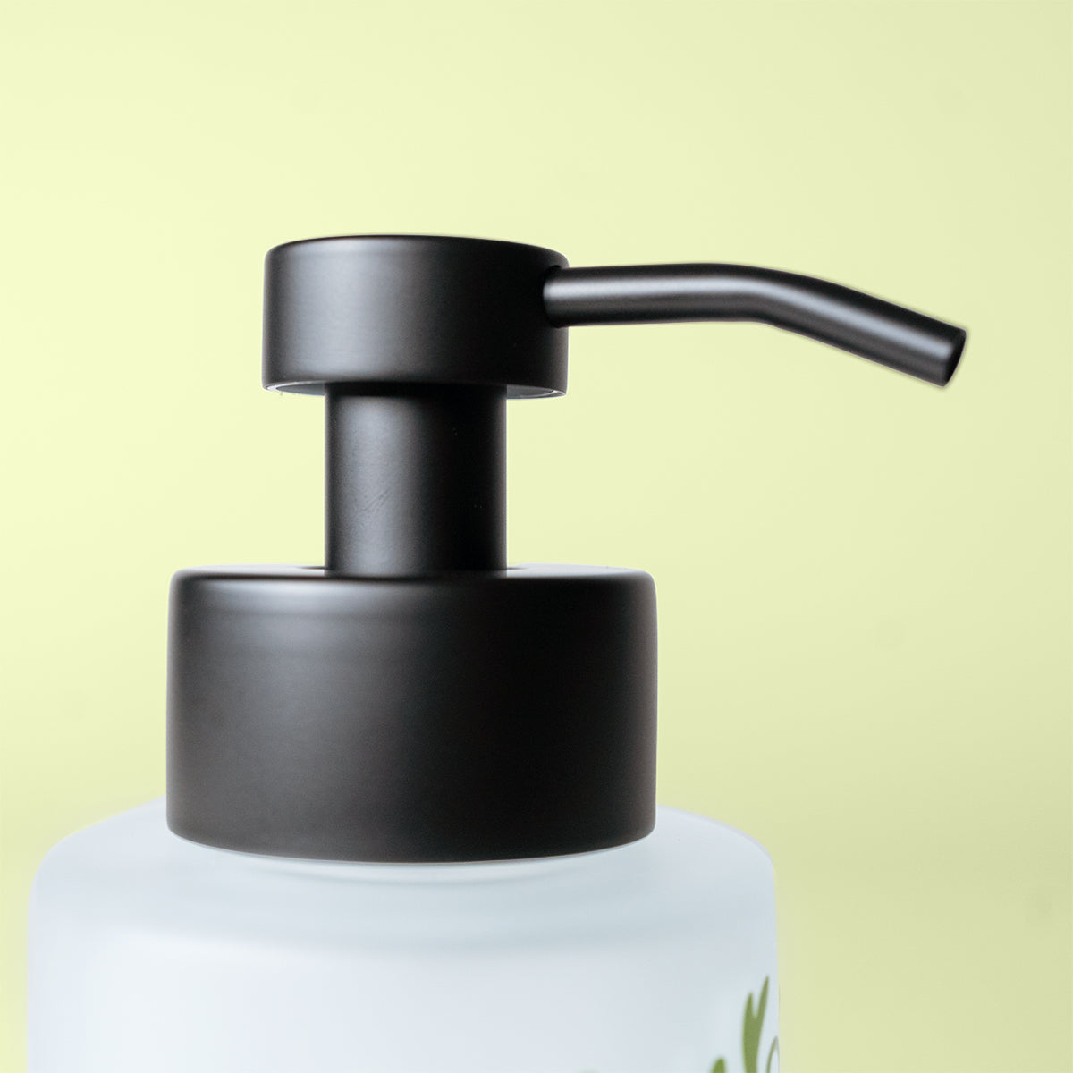 Black pump dispenser on a white bottle against a light green background
