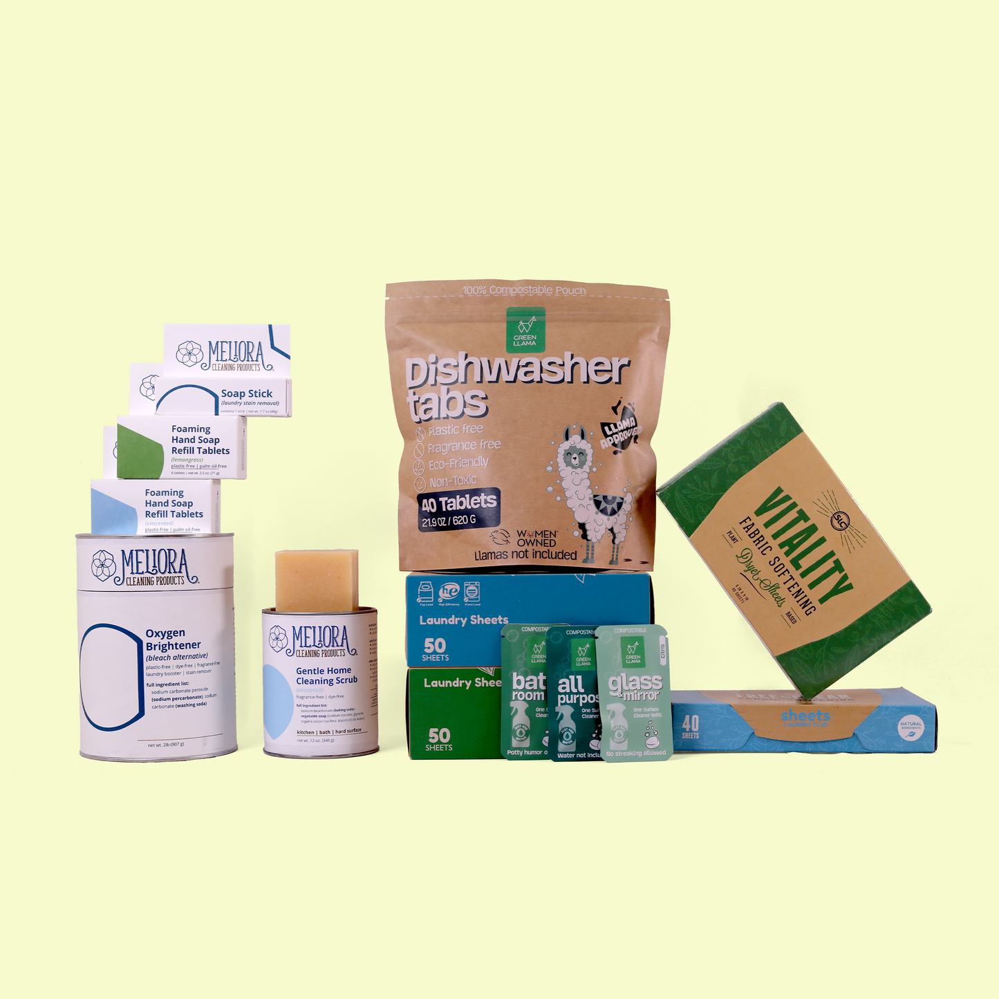 A collection of eco-friendly cleaning products displayed against a yellow background. Features Meliora cleaning products (Oxygen Brightener, Soap Stick, and scrubs), Sheets Laundry Club detergent, and dryer sheets, Green Llama cleaning packets. The arrangement showcases sustainable alternatives to conventional household cleaners. Build your own cleaning bundle from EcoGeek a Good Store product.