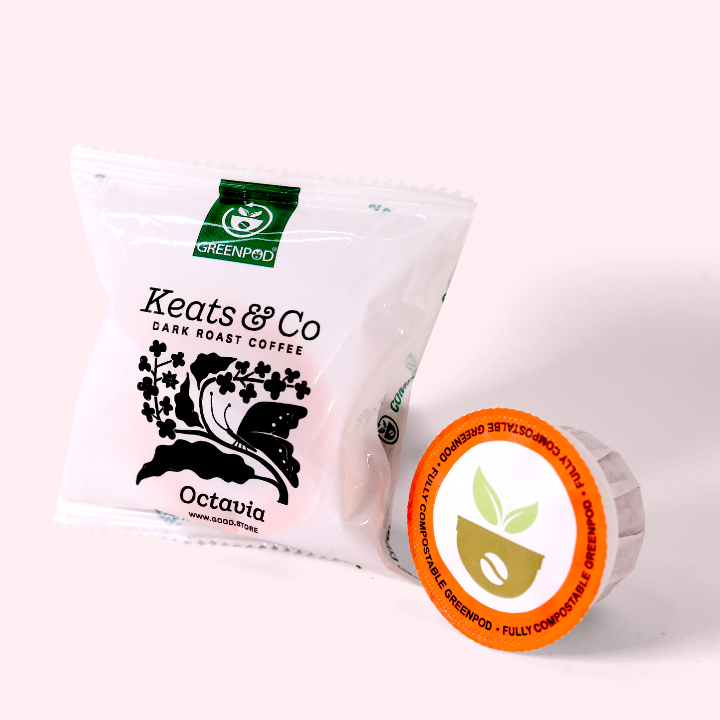 A white coffee packet labeled "Keats & Co Dark Roast Coffee Octavia" with a black floral design, next to a single-serve coffee pod with an orange circular label.