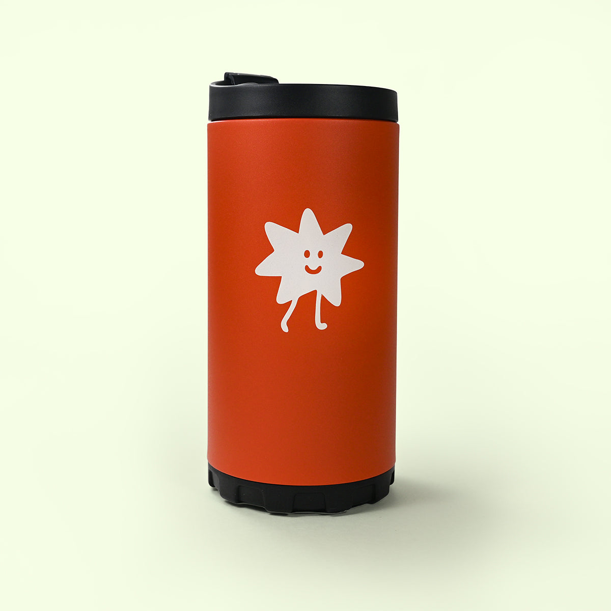 Burnt orange french press with a white star-shaped logo on a beige background