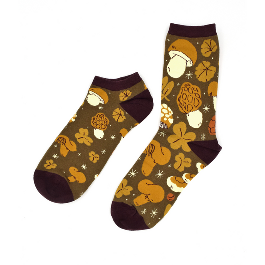 The September 2023 Awesome Sock is tones of brown with illustrations of mushrooms and leaves on it, comes in ankle and crew sock. A Good Store product.