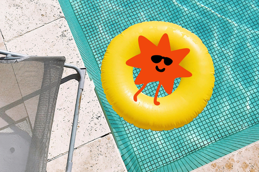 Good Store's mascot, Dot floating in a pool on a yellow tube