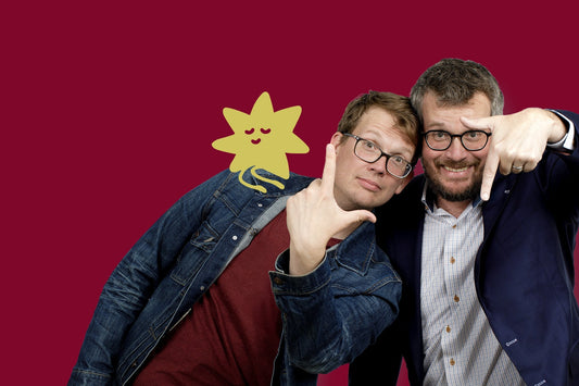 Image of Hank and John Green over a maroon background