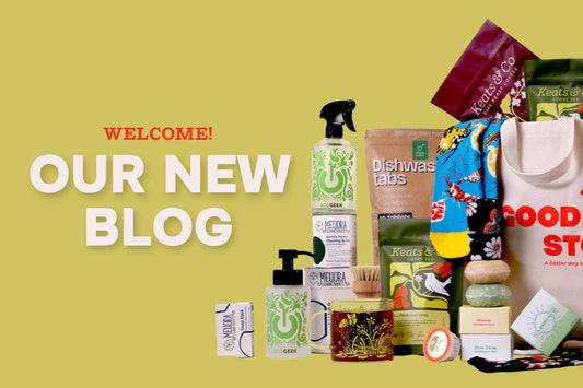 Image of Good Store products over a green background. products shown include socks, soap, laundry detergent, tea, and more. Text says "Welcome! Our New Blog!"