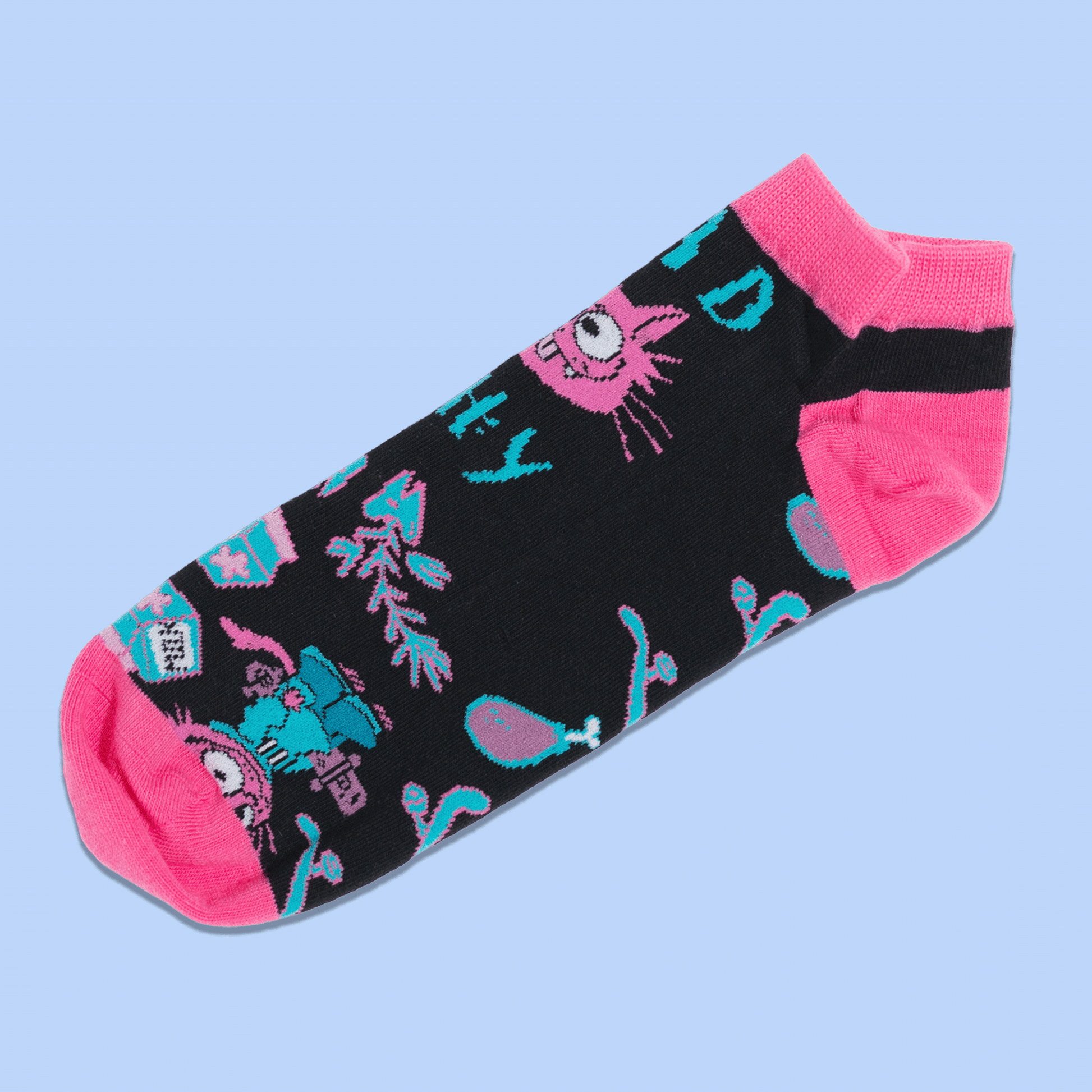 A pair of black crew socks with bright pink toes, heels, and cuffs, featuring a colorful cartoon cat and teal text and pattern details, displayed against a light blue background.