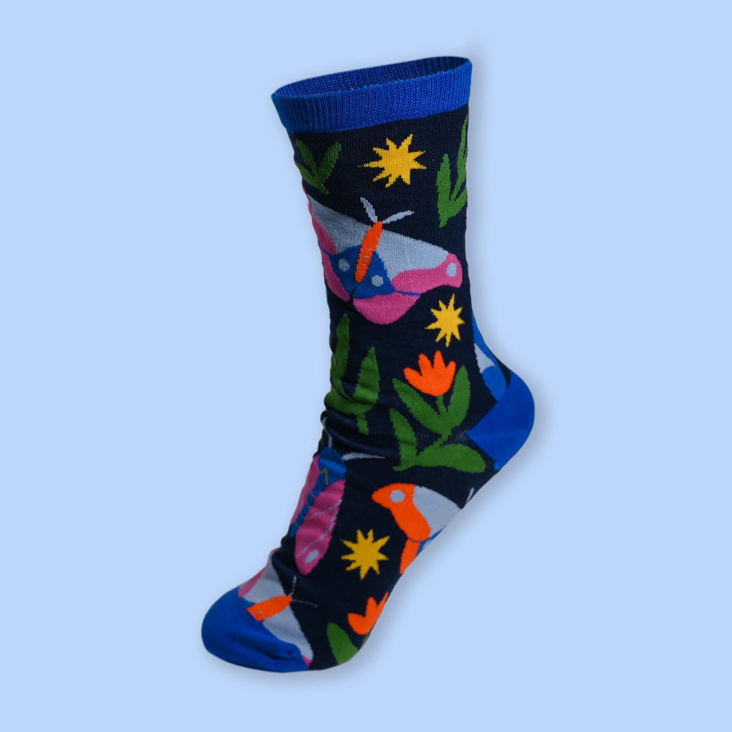 Colorful sock with floral and moth design on a light blue background