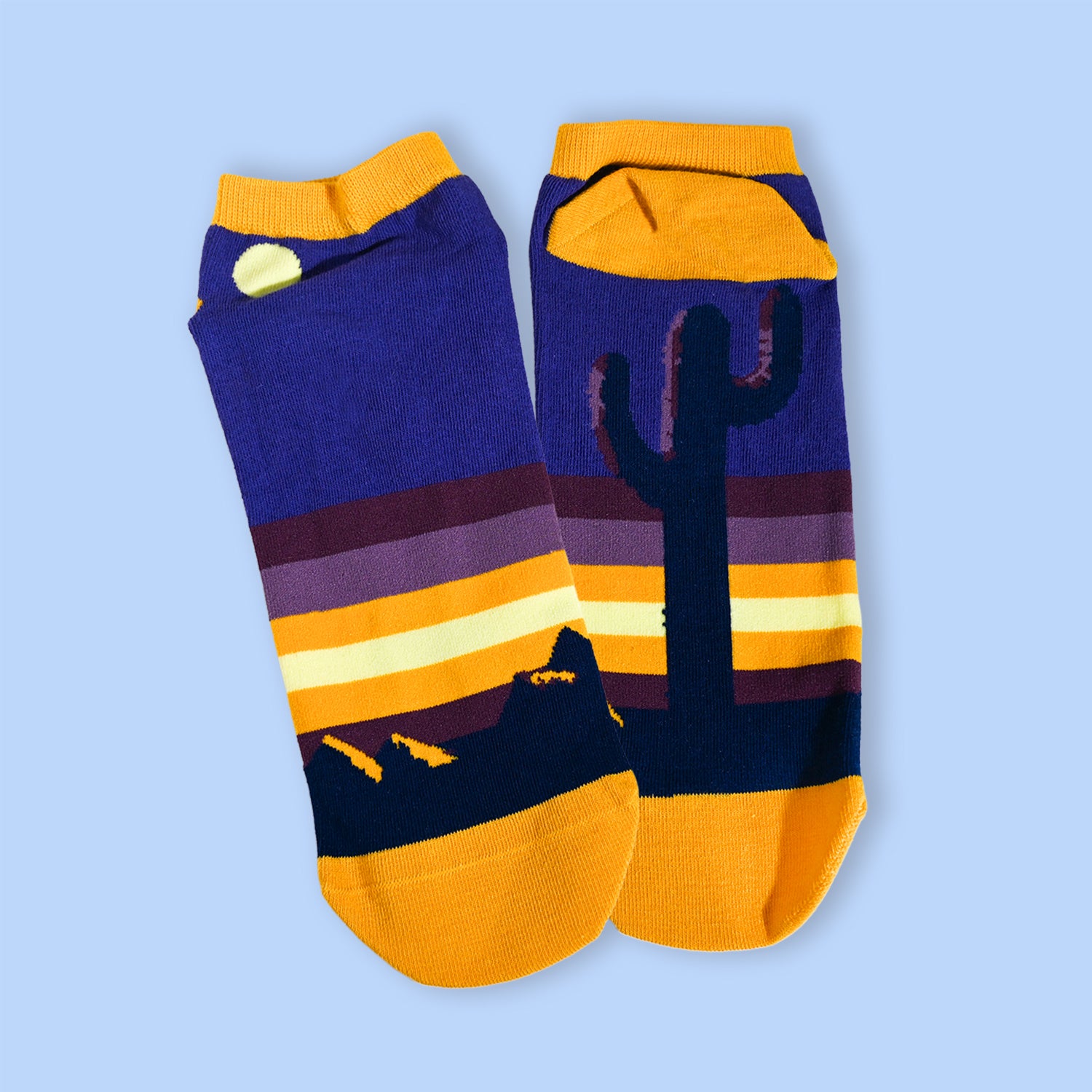 Colorful socks with cactus design on a light blue background