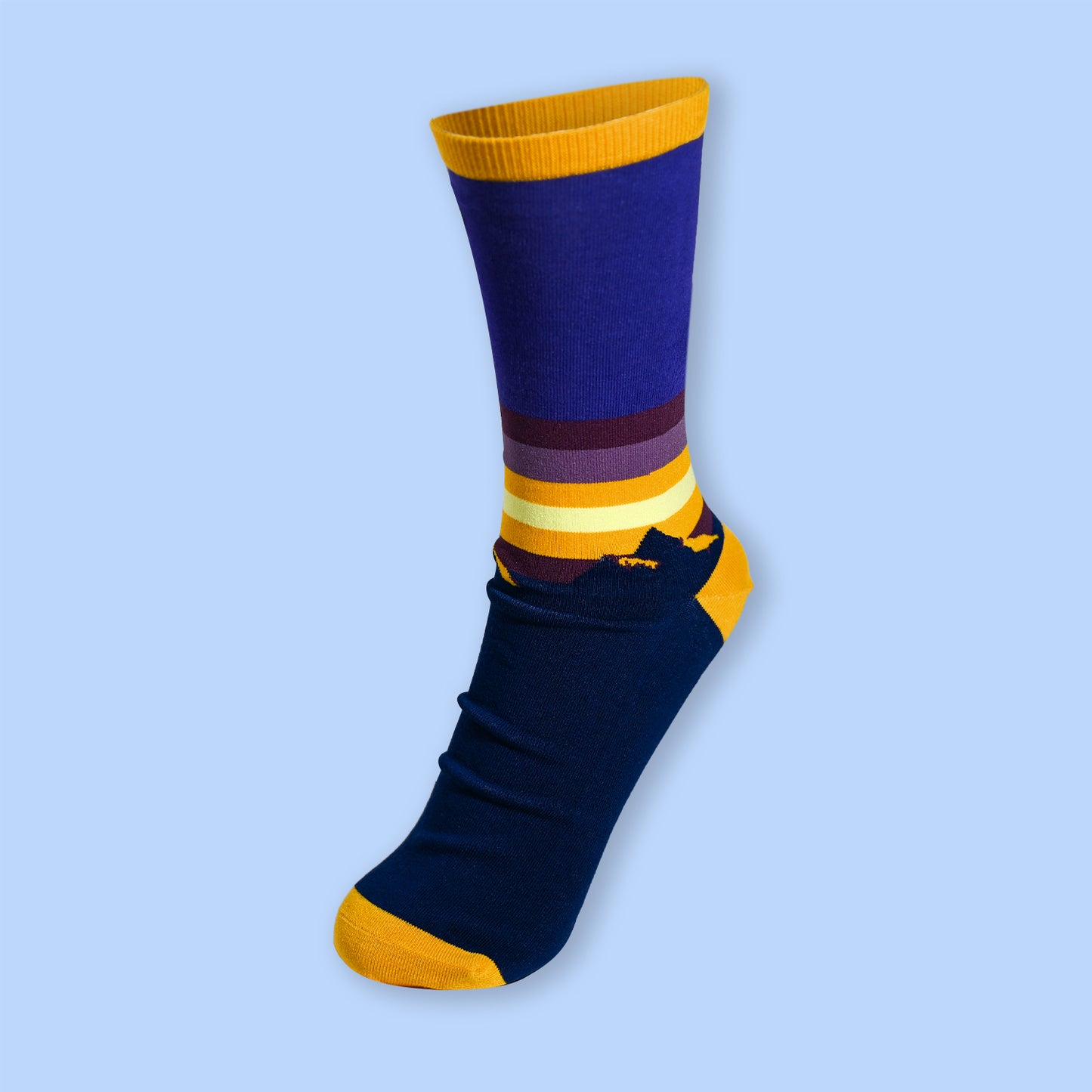 Blue sock with yellow accents on a light blue background