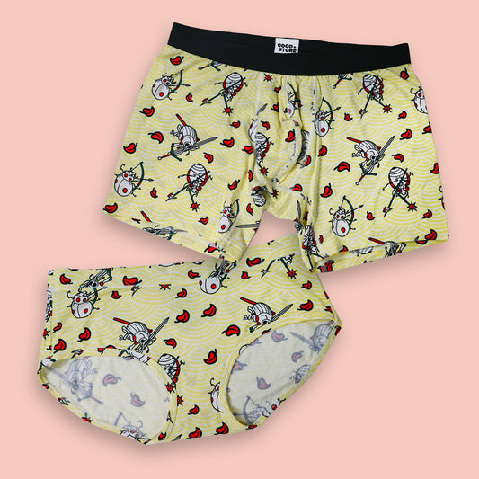 Pair of boxer briefs with a cartoon character pattern on a pink background