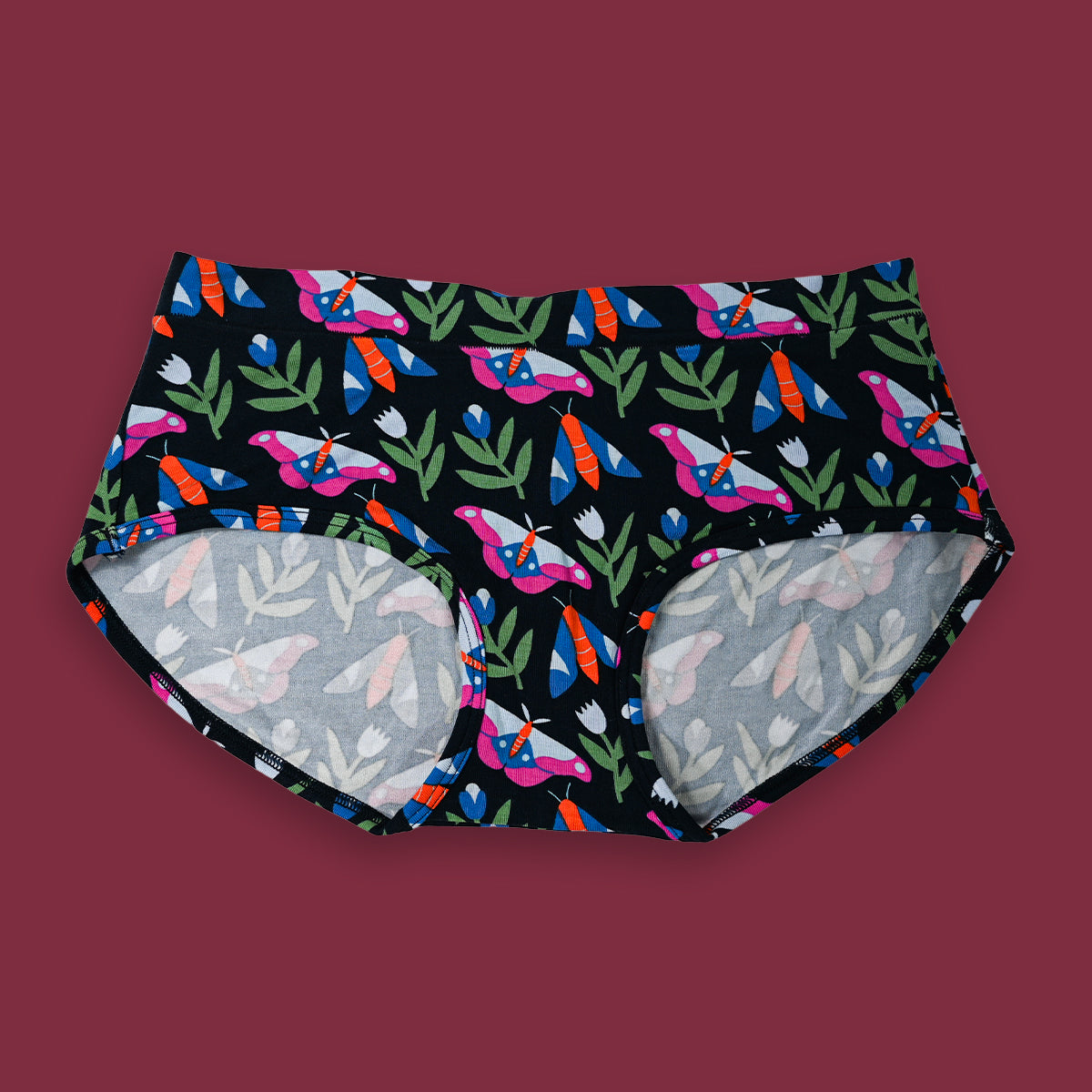 Colorful butterfly patterned underwear on a dark background