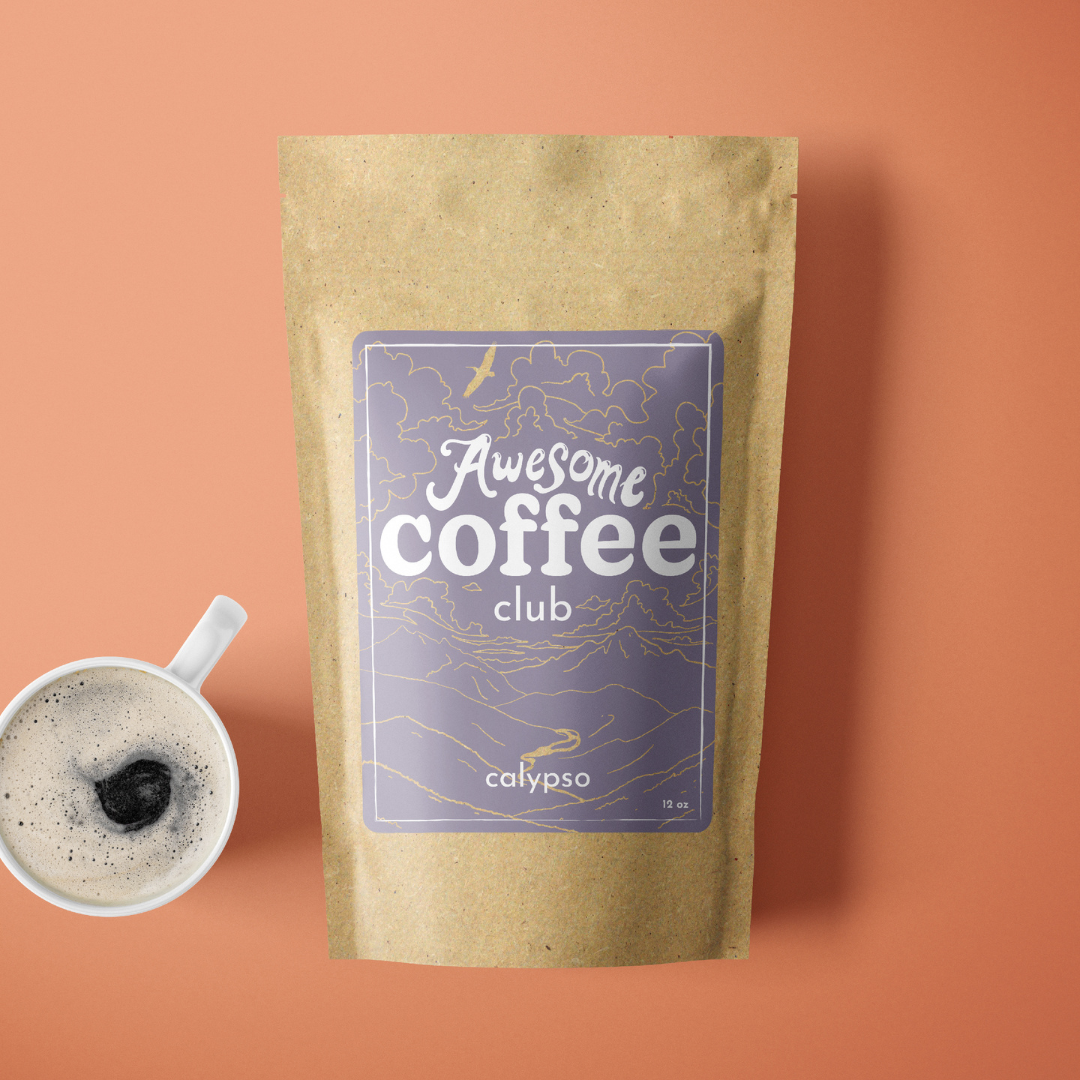 A photo of a brown bag of coffee with a light purple label that shows a mountain scene and has the text "Awesome Coffee Club; Calypso". The bag sites atop a light orange background with a cup of coffee next to it. A Good Store subscription.