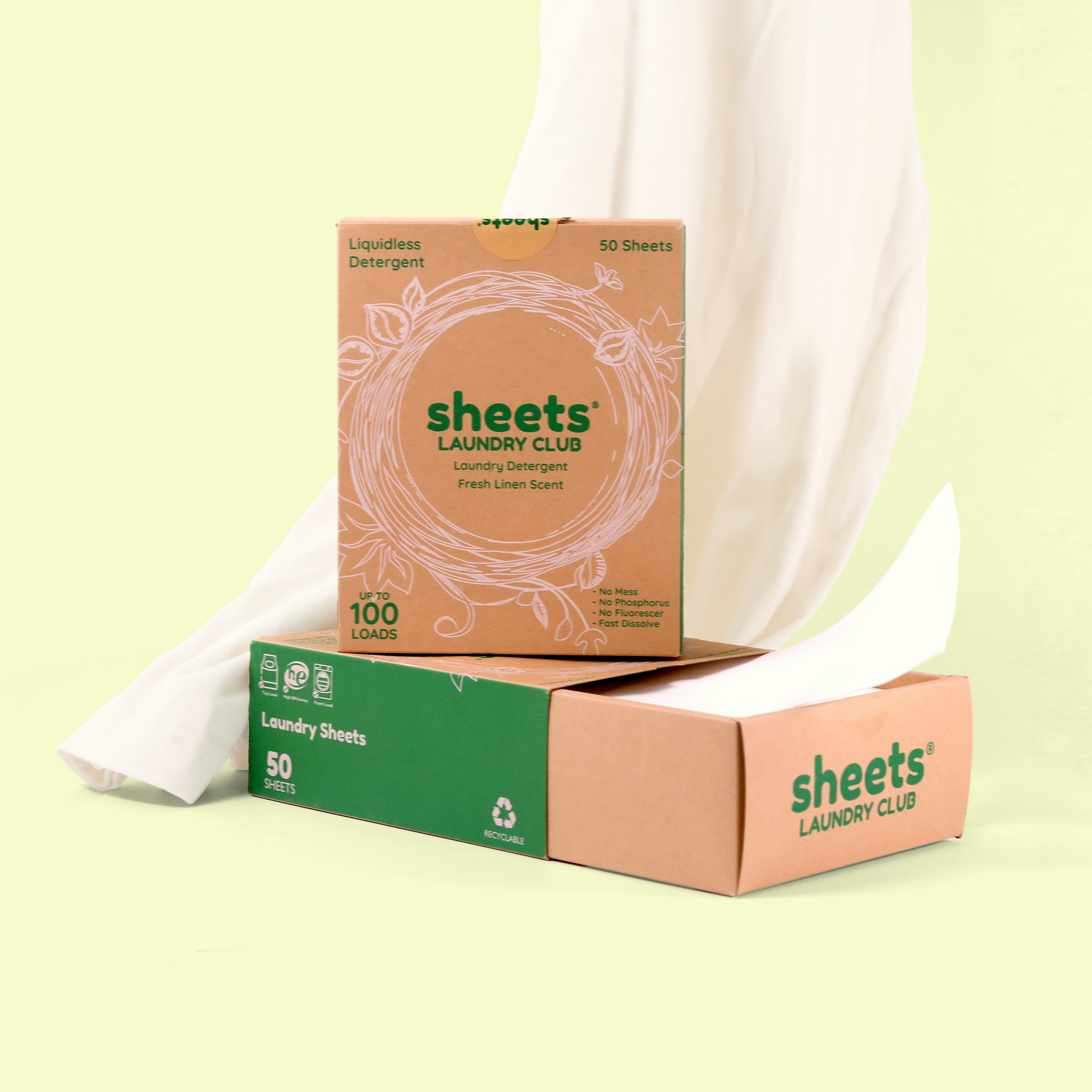 Sheets Laundry Club products against a white fabric and pale yellow background. The top box advertises "Fresh Linen Scent" detergent with "Up to 100 LOADS." Below is a green-accented box of "50 SHEETS," and a third box with a white sheet partially visible. Laundry detergent sheets from EcoGeek a Good Store product.