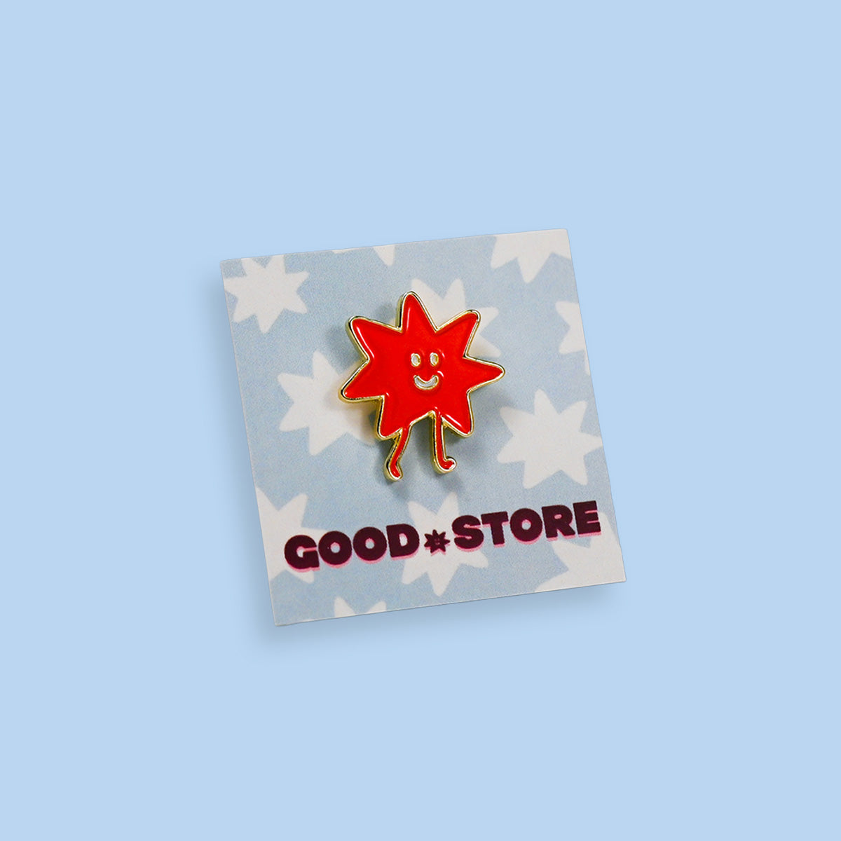 Blue background with orange Dot pin with gold outline with a pin on a backing with blue Dots with logo text Good Store. 