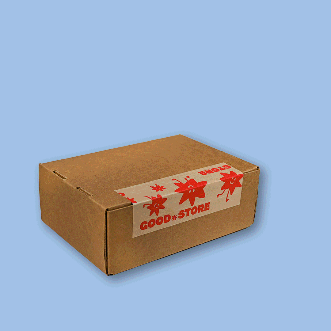 Open cardboard care package with tea packaging and a strainer on a light blue background