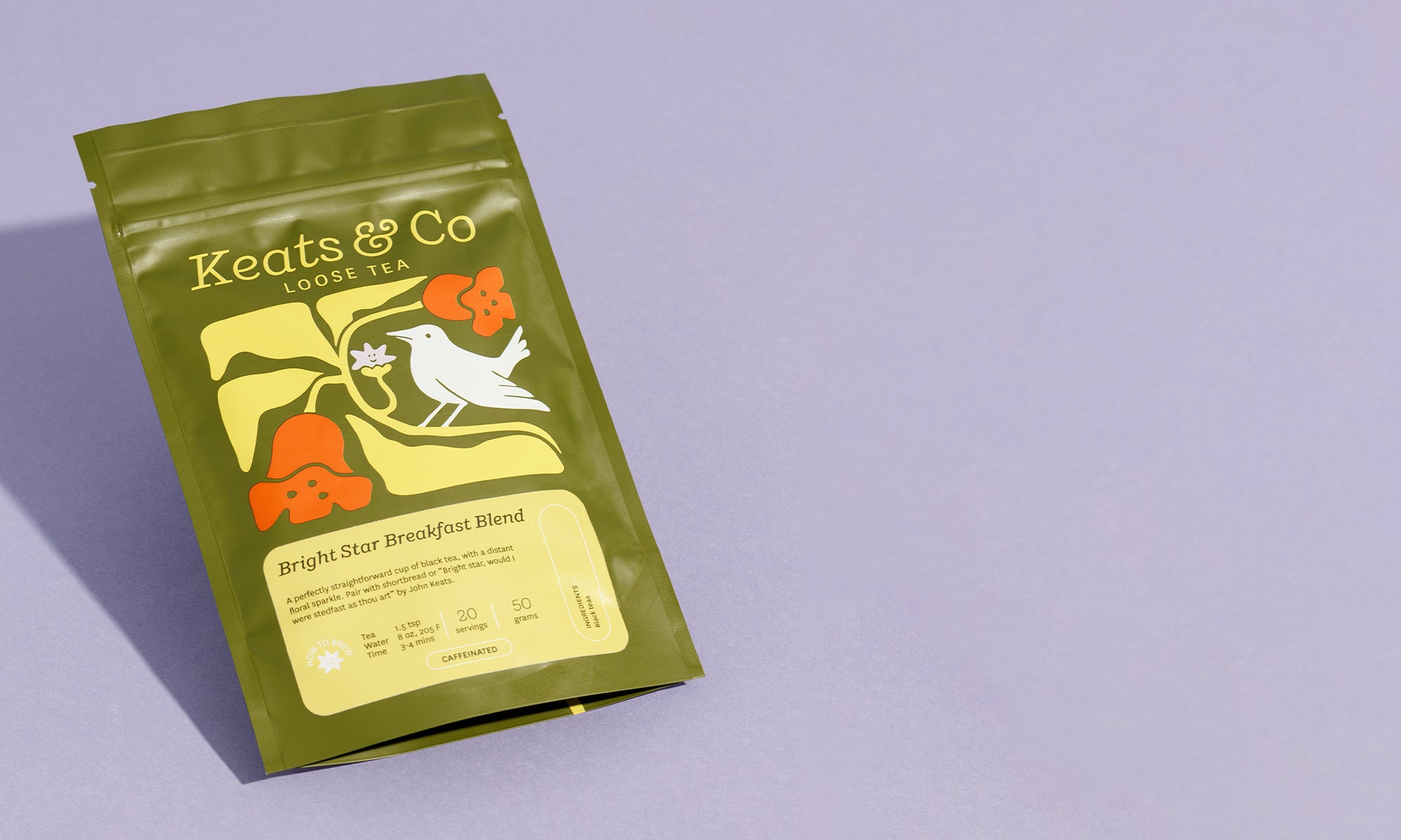 Green tea package with floral design and 'Keats & Co' branding on a light purple background