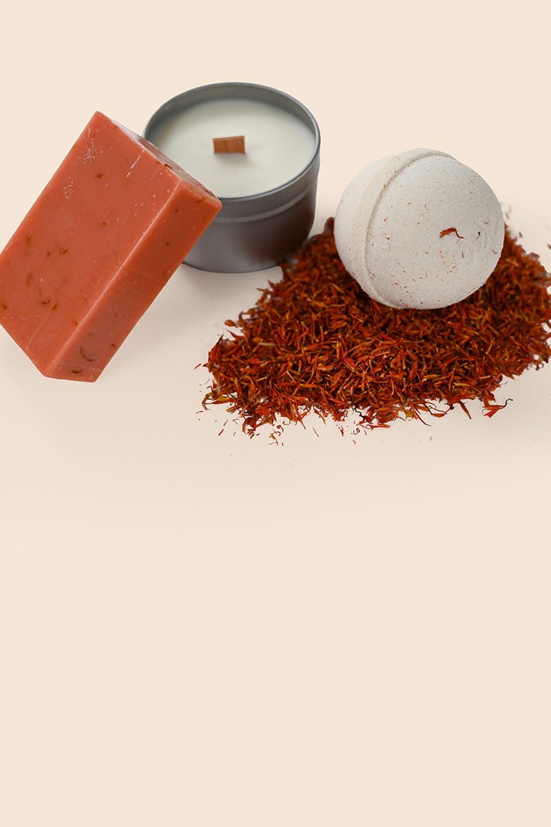 Bar of soap, a candle, and bath bomb on a beige background