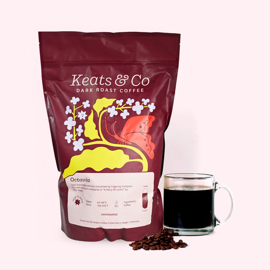 Photo of 5lb bag of Octavia, dark roast coffee from Keats & Co next to a mug of coffee.