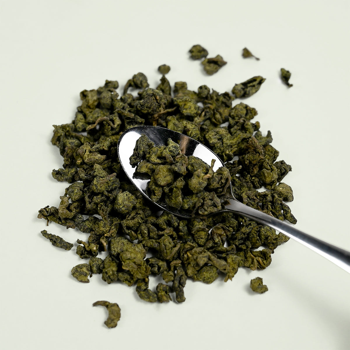 Photo of Oolong tea leaves with a spoon in them. Part of the Keats & Co collection from Good Store. 