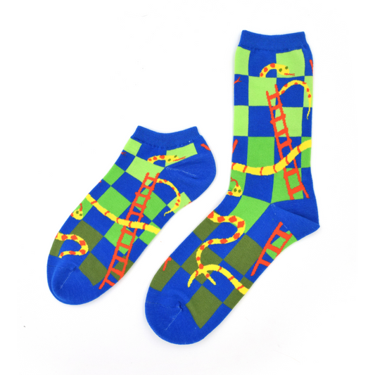 Two past designs from the Awesome Socks Club, one ankle, one crew, with a green and blue checkered background with snakes and ladders throughout. A Good Store product.