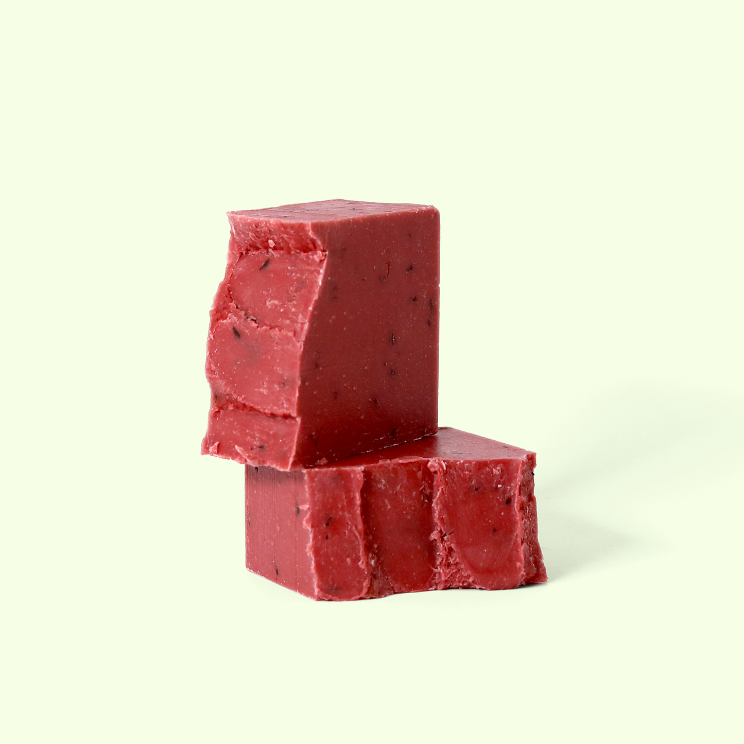  Two cubes of deep red soap with visible specks and rough edges, stacked on each other against a light background. Sun Basin Soap - Good Store.