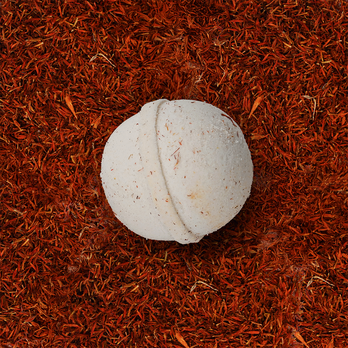 Bath bombs on a background of various loose herbs and dried flowers